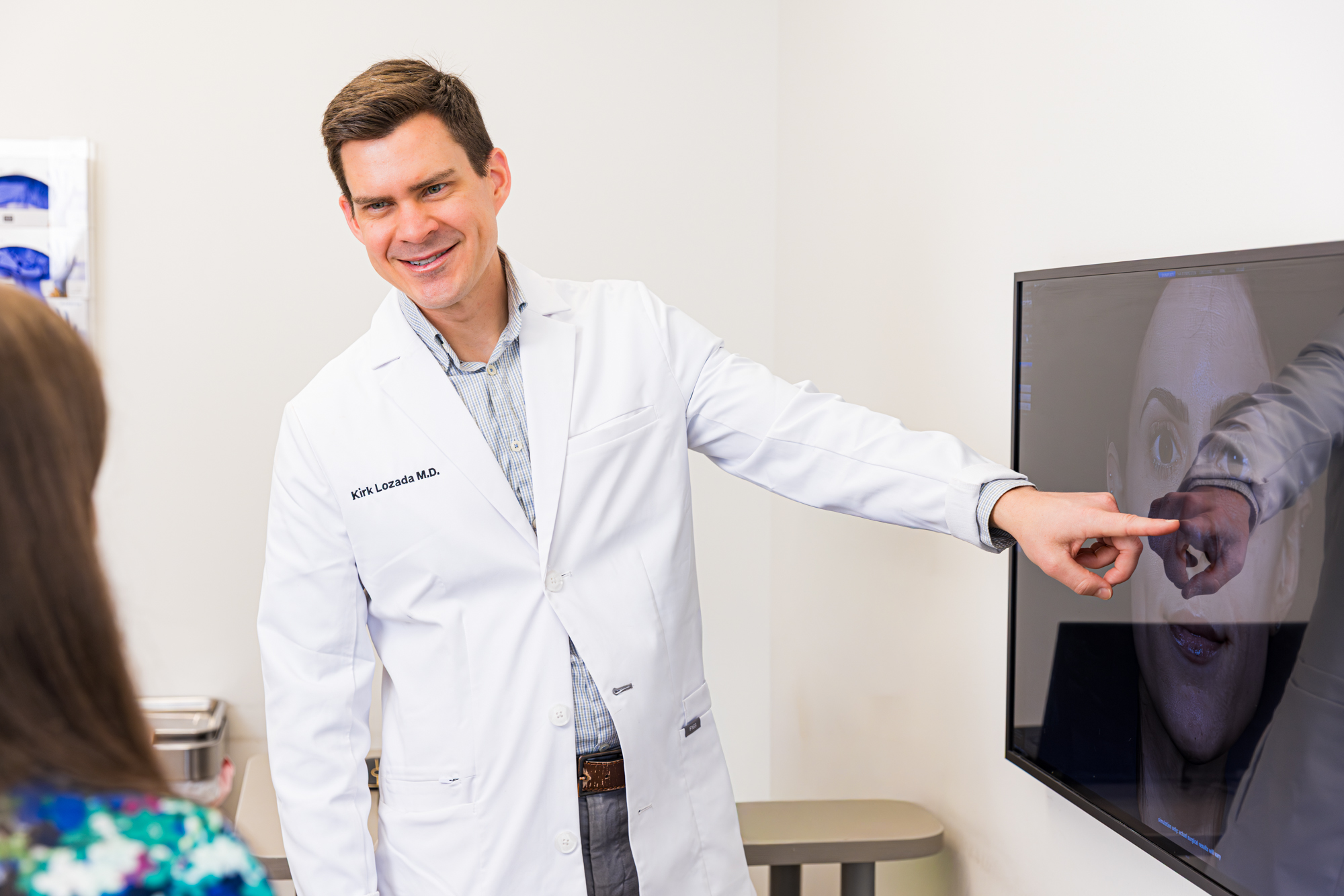 Dr. Lozada consulting with a patient.